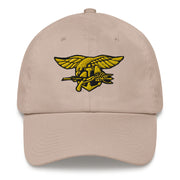 A stone colored Navy Seals Hat with the logo on the front.  The hat has a curved visor and an adjustable strap at the back.