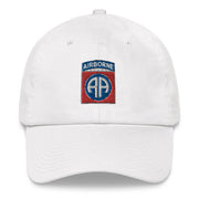 A white 82nd Airborne Hat with the logo on the front.  The hat has a curved visor and an adjustable strap at the back.