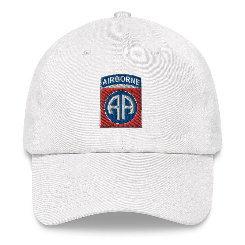 A white 82nd Airborne Hat with the logo on the front.  The hat has a curved visor and an adjustable strap at the back.