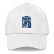 A white XVIII Airborne Corps Hat with the logo on the front.  The hat has a curved visor and an adjustable strap at the back.