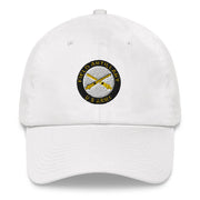 A white US Army Field Artillery Hat with the logo on the front.  The hat has a curved visor and an adjustable strap at the back.