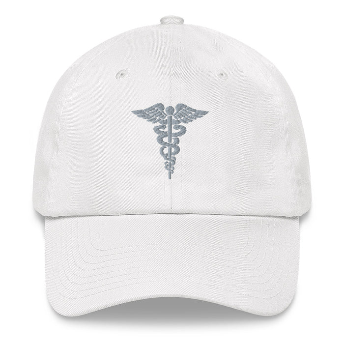 A white Hospital Corpsman Hat with the logo on the front.  The hat has a curved visor and an adjustable strap at the back.