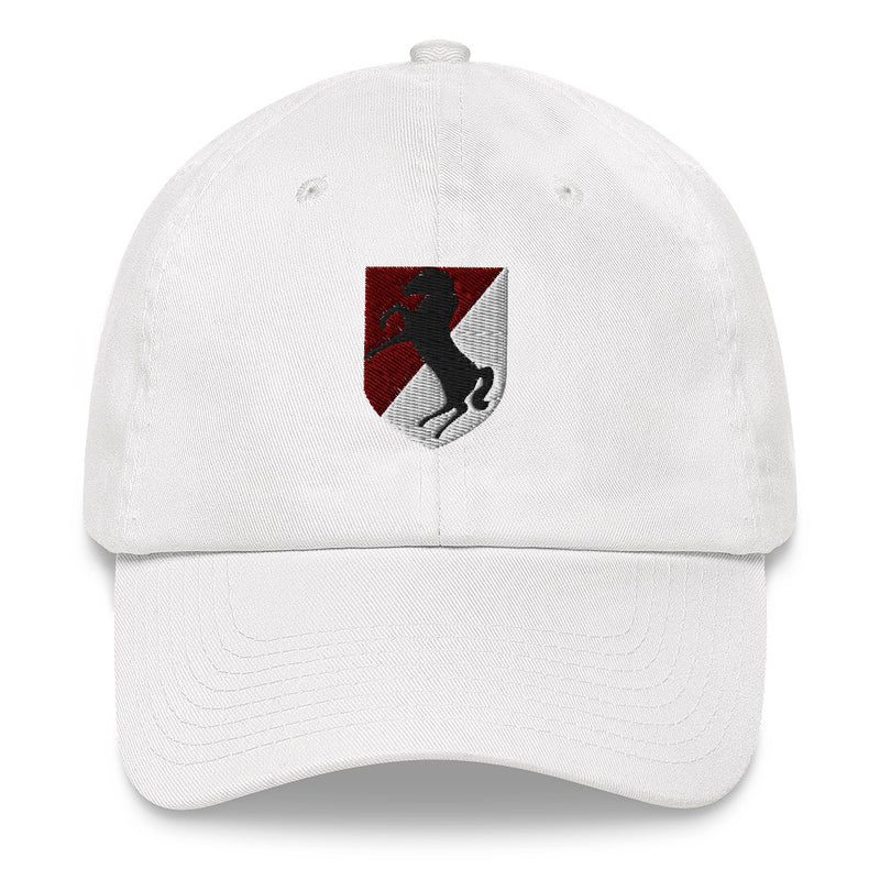 A white 11th Armored Cavalry Regiment Hat with the logo on the front.  The hat has a curved visor and an adjustable strap at the back.