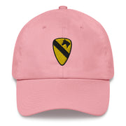 A pink 1st Cavalry Division Hat with the logo on the front.  The hat has a curved visor and an adjustable strap at the back.