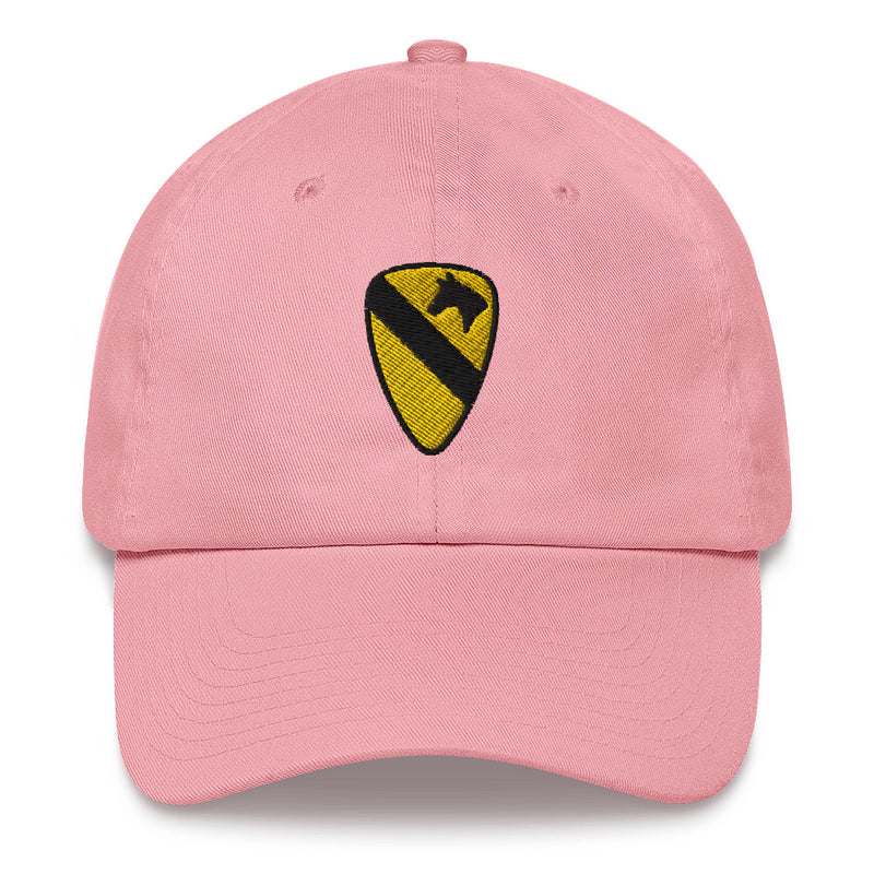 A pink 1st Cavalry Division Hat with the logo on the front.  The hat has a curved visor and an adjustable strap at the back.