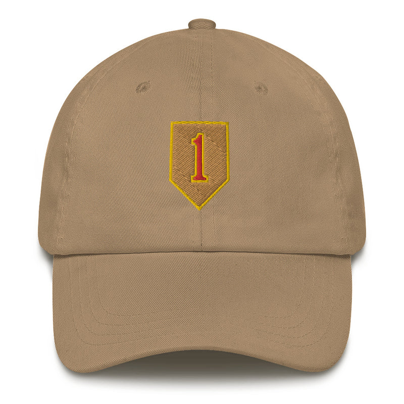 A khaki colored 1st Infantry Division Hat with the logo on the front.  The hat has a curved visor and an adjustable strap at the back.