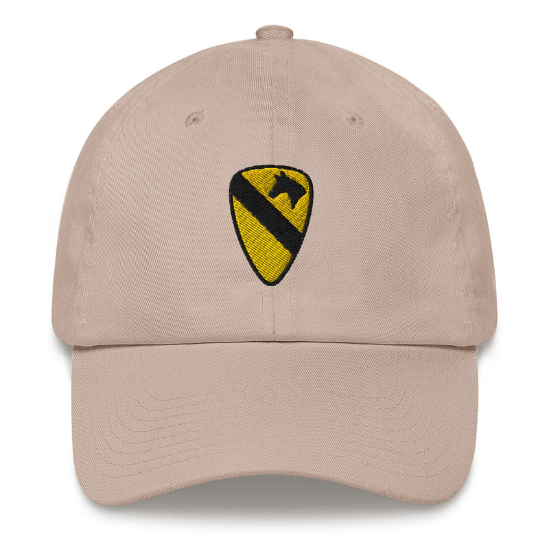 A stone colored 1st Cavalry Division Hat with the logo on the front.  The hat has a curved visor and an adjustable strap at the back.