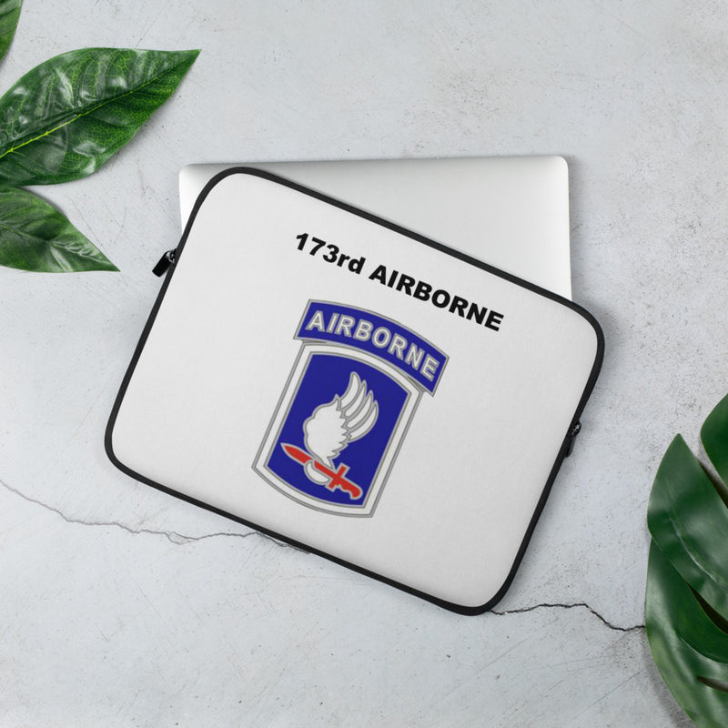 A lightweight and water-resistant white Laptop Sleeve with the 173rd Airborne Brigade logo printed on top. The laptop sleeve is designed to fit a 13" laptop.
