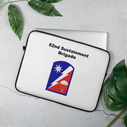 A lightweight and water-resistant white Laptop Sleeve with the 82nd Sustainment Brigade logo printed on top. The laptop sleeve is designed to fit a 15" laptop.