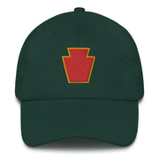 A spruce colored 28th Infantry Division Hat with the logo on the front.  The hat has a curved visor and an adjustable strap at the back.