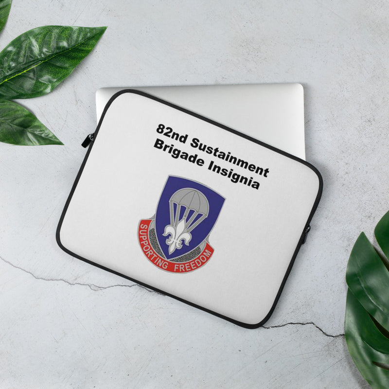 A lightweight and water-resistant white Laptop Sleeve with the 82nd Sustainment Brigade Insignia logo printed on top. The laptop sleeve is designed to fit a 13" laptop.