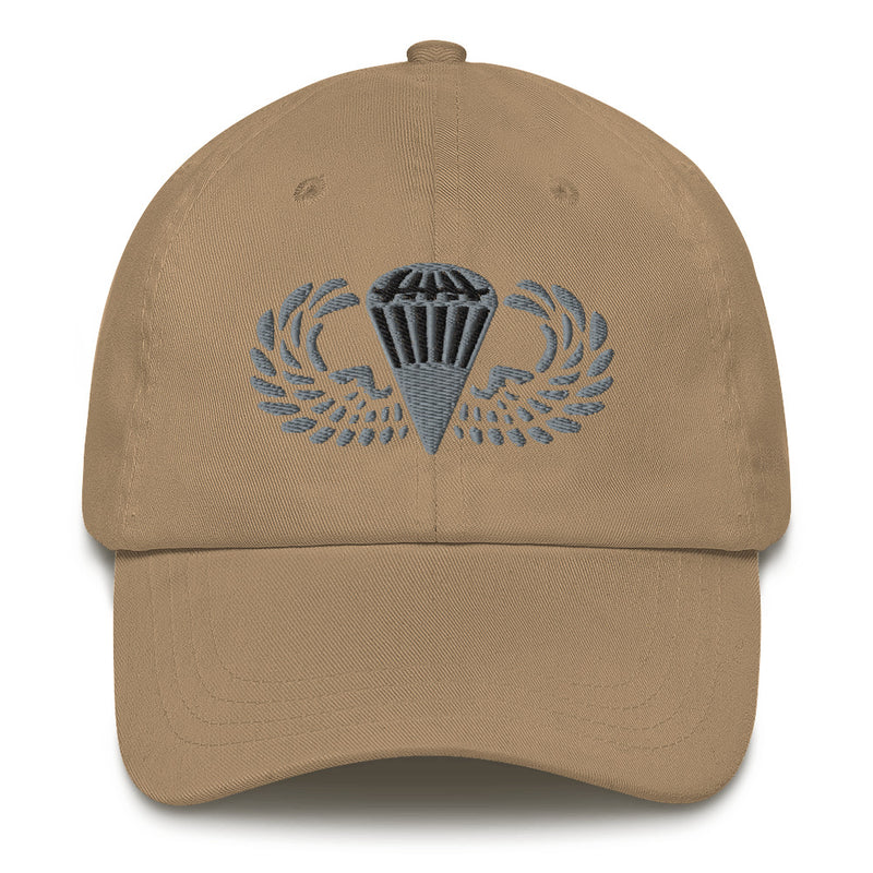 A khaki colored Basic Parachutist Hat with the logo on the front.  The hat has a curved visor and an adjustable strap at the back.