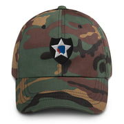 A military style 2nd Infantry Division Hat with camouflage and the logo on the front.  The hat has a curved visor and an adjustable strap at the back. 