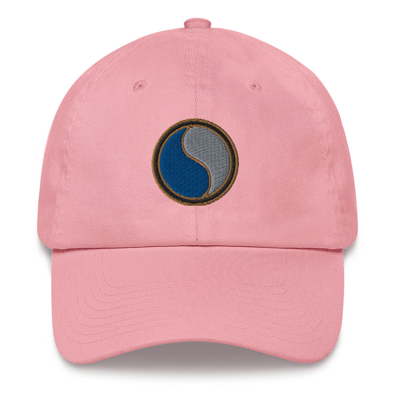 A pink 29th Infantry Division Hat with the logo on the front.  The hat has a curved visor and an adjustable strap at the back.