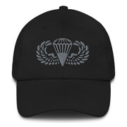 A black Basic Parachutist Hat with the logo on the front.  The hat has a curved visor and an adjustable strap at the back.