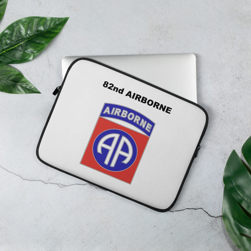 A lightweight and water-resistant white Laptop Sleeve with the 82nd Airborne logo printed on top. The laptop sleeve is designed to fit a 13" laptop.