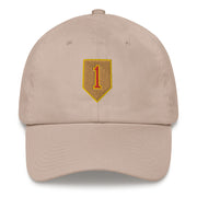 A stone colored 1st Infantry Division Hat with the logo on the front.  The hat has a curved visor and an adjustable strap at the back.