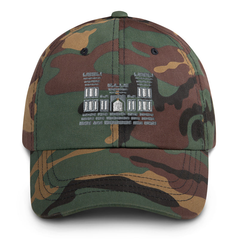 A military style Combat Engineer Hat with camouflage and the logo on the front.  The hat has a curved visor and an adjustable strap at the back. 