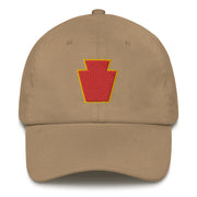 A khaki colored 28th Infantry Division Hat with the logo on the front.  The hat has a curved visor and an adjustable strap at the back.