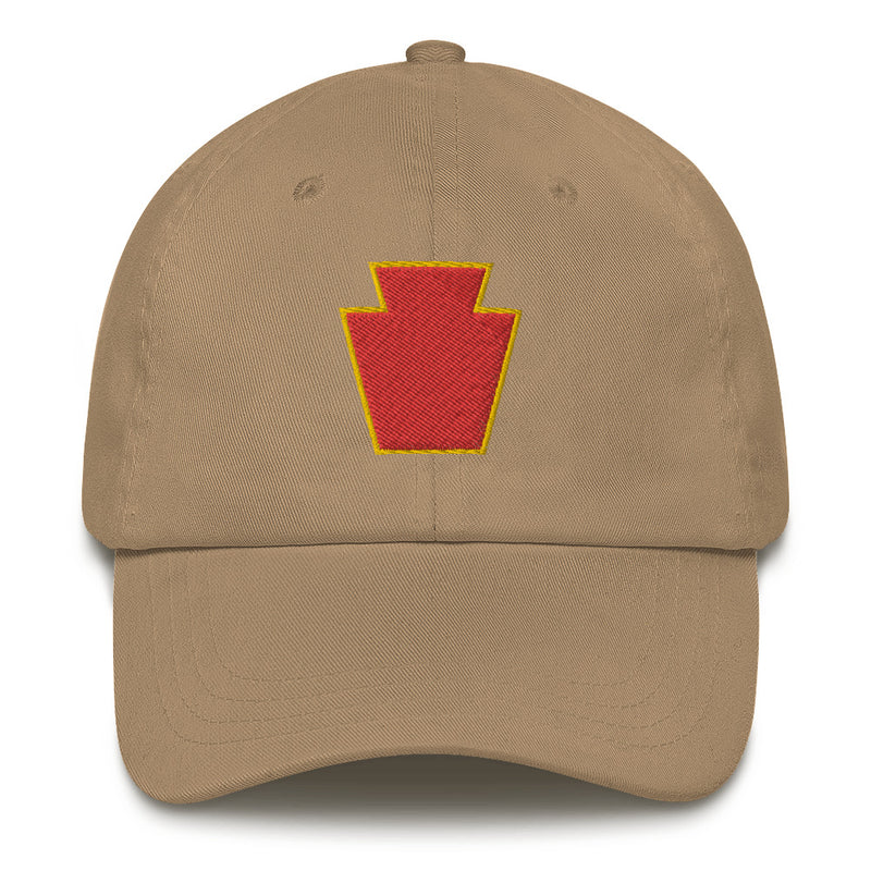 A khaki colored 28th Infantry Division Hat with the logo on the front.  The hat has a curved visor and an adjustable strap at the back.