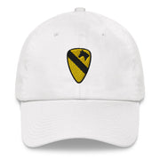 A white 1st Cavalry Division Hat with the logo on the front.  The hat has a curved visor and an adjustable strap at the back.