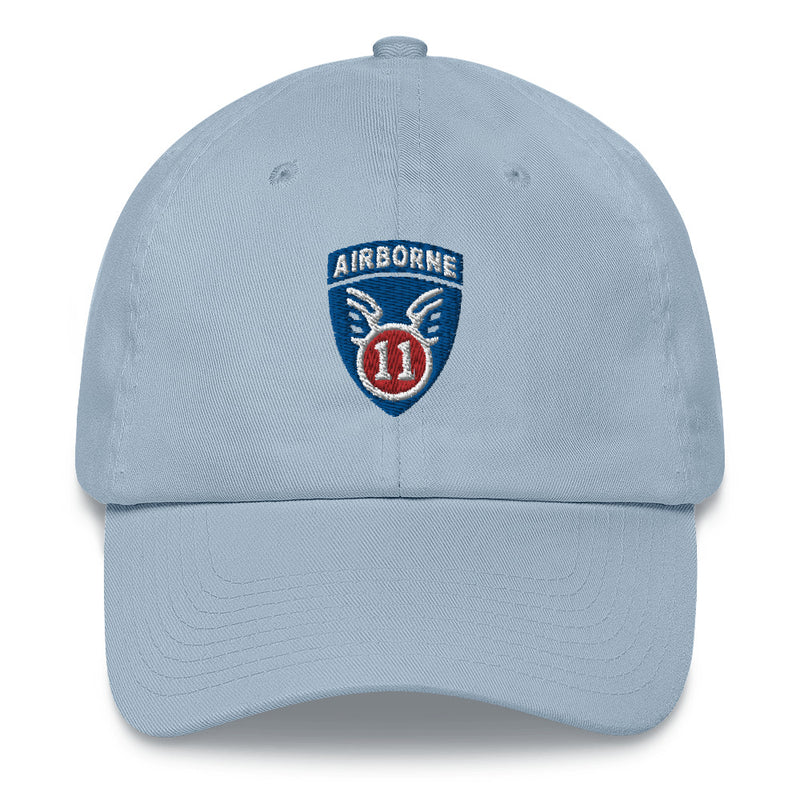 A light blue 11th Airborne Division Hat with the logo on the front.  The hat has a curved visor and an adjustable strap at the back.