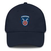 A navy blue 11th Airborne Division Hat with the logo on the front.  The hat has a curved visor and an adjustable strap at the back.