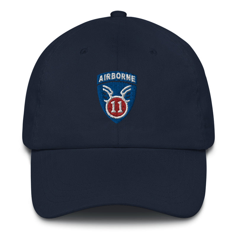 A navy blue 11th Airborne Division Hat with the logo on the front.  The hat has a curved visor and an adjustable strap at the back.