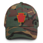 A military style 28th Infantry Division Hat with camouflage and the logo on the front.  The hat has a curved visor and an adjustable strap at the back. 