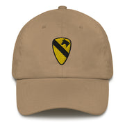 A khaki colored 1st Cavalry Division Hat with the logo on the front.  The hat has a curved visor and an adjustable strap at the back.