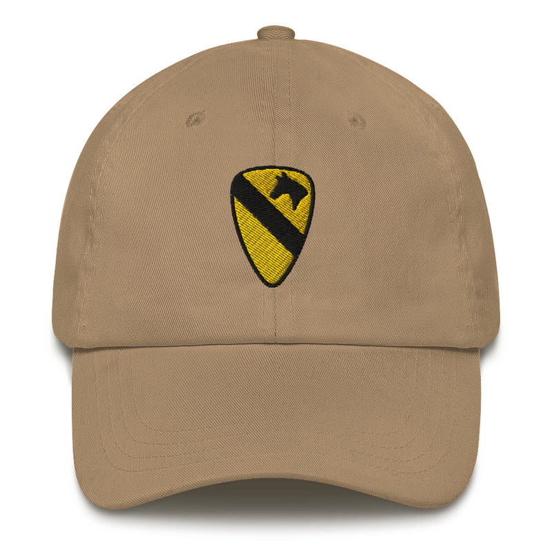 A khaki colored 1st Cavalry Division Hat with the logo on the front.  The hat has a curved visor and an adjustable strap at the back.