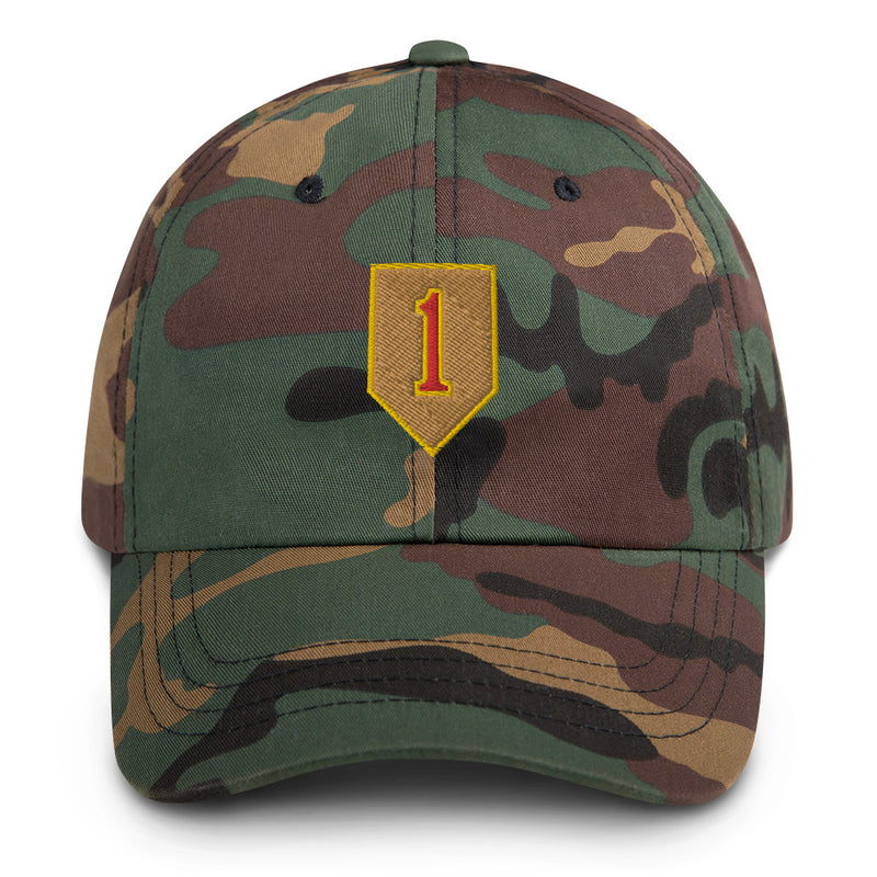 A military style 1st Infantry Division Hat with camouflage and the logo on the front.  The hat has a curved visor and an adjustable strap at the back. 