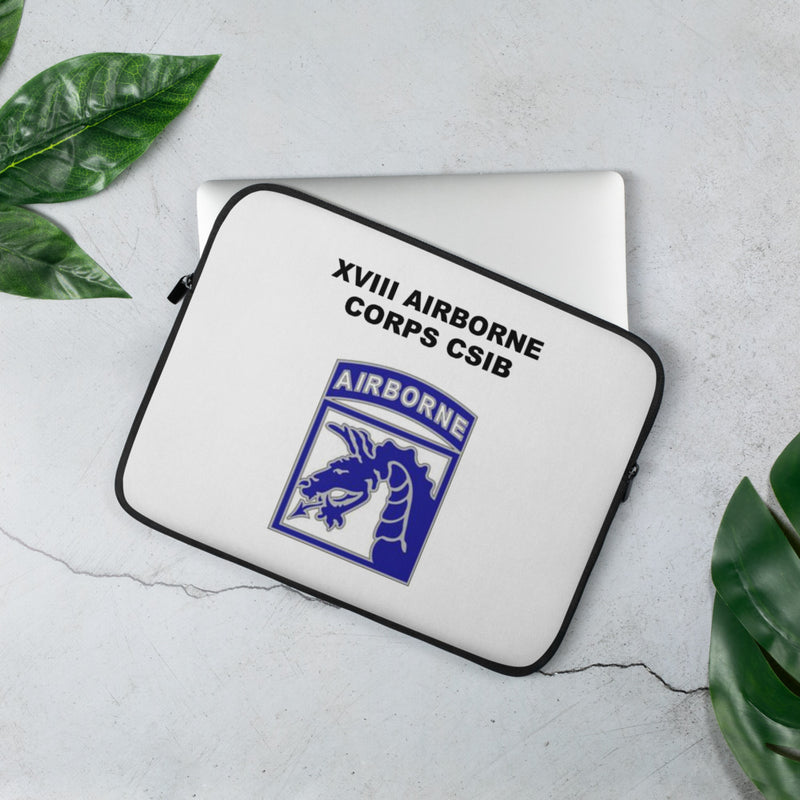 A lightweight and water-resistant white Laptop Sleeve with the XVIII Airborne Corps logo printed on top. The laptop sleeve is designed to fit a 13" laptop.