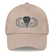 A stone colored Basic Parachutist Hat with the logo on the front.  The hat has a curved visor and an adjustable strap at the back.