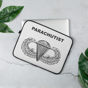 A lightweight and water-resistant white Laptop Sleeve with the Basic Parachutist logo printed on top. The laptop sleeve is designed to fit a 13" laptop.