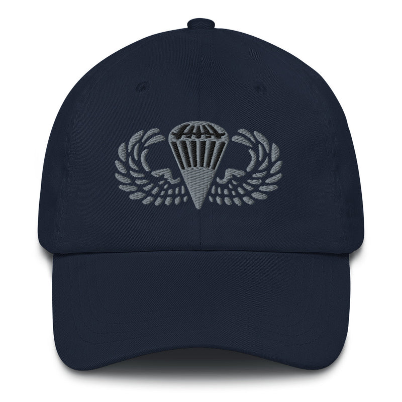 A navy blue Basic Parachutist Hat with the logo on the front.  The hat has a curved visor and an adjustable strap at the back.