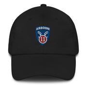 A black 11th Airborne Division Hat with the logo on the front.  The hat has a curved visor and an adjustable strap at the back.