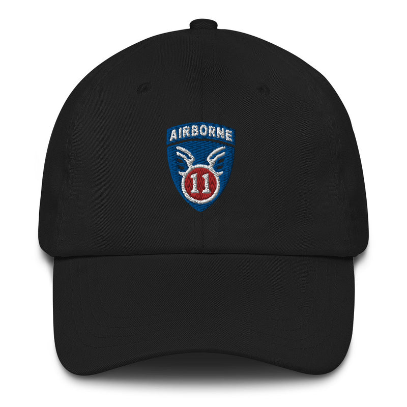 A black 11th Airborne Division Hat with the logo on the front.  The hat has a curved visor and an adjustable strap at the back.