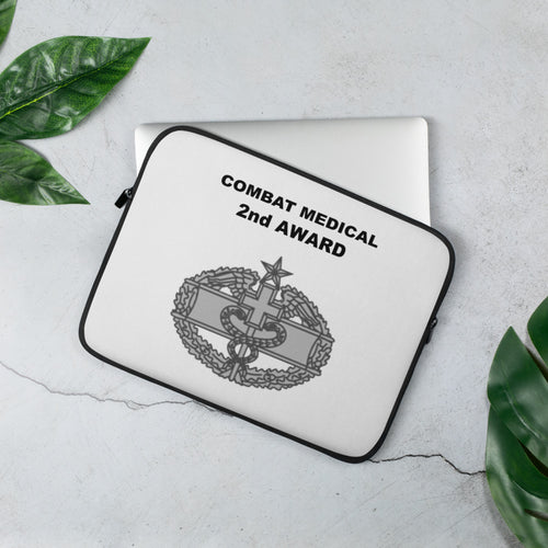 A lightweight and water-resistant white Laptop Sleeve with the Combat Medical 2nd Award logo printed on top. The laptop sleeve is designed to fit a 13" laptop.
