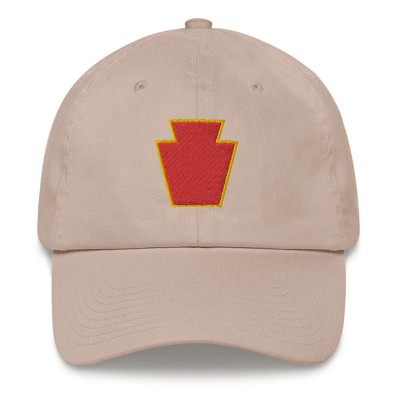 A stone colored 28th Infantry Division Hat with the logo on the front.  The hat has a curved visor and an adjustable strap at the back.