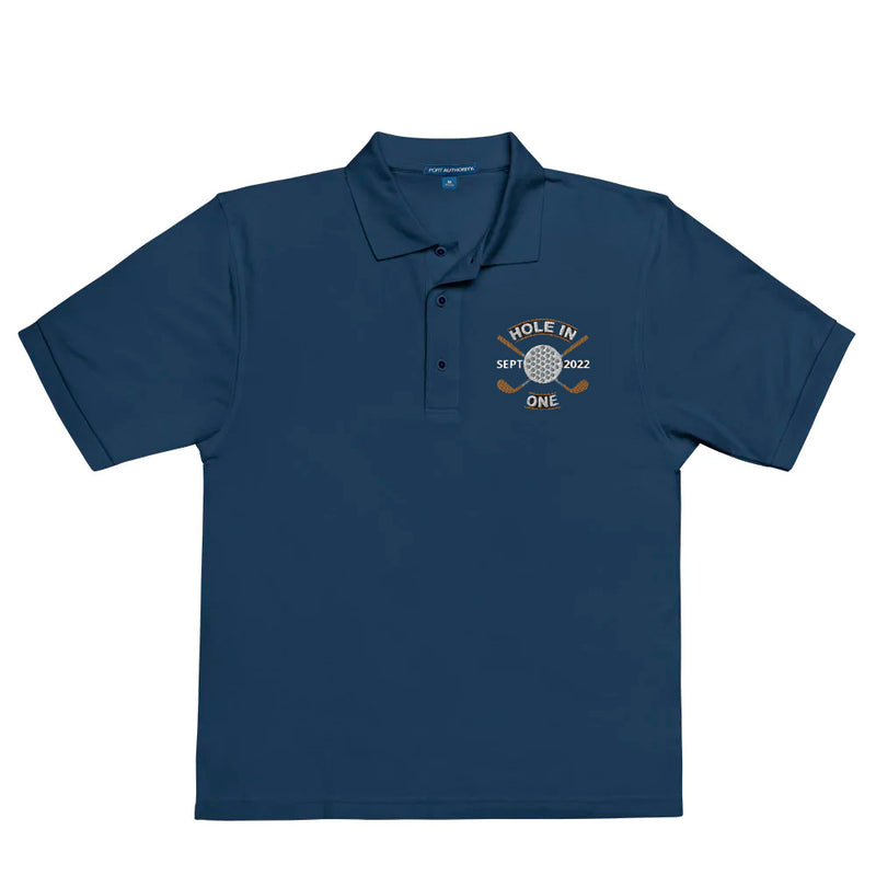 "Hole in One with Personalized Month and Year" - Navy Golf shirt • 65% polyester, 35% cotton pique • Relaxed fit that runs large • Flat knit collar and cuffs