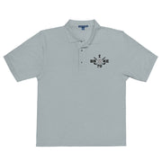 "I Broke 70" - Cool Heather Golf shirt • 65% polyester, 35% cotton pique • Relaxed fit that runs large • Flat knit collar and cuffs