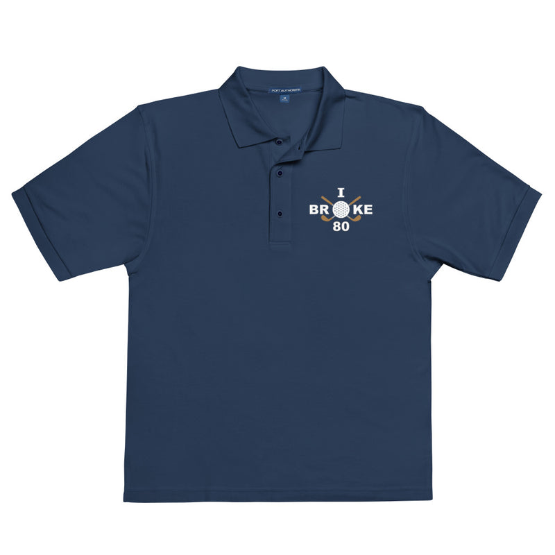 "I Broke 80" - Navy Golf shirt • 65% polyester, 35% cotton pique • Relaxed fit that runs large • Flat knit collar and cuffs