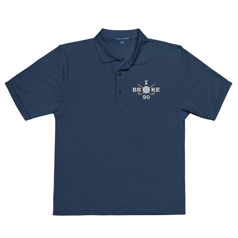 "I Broke 90" - Navy Golf shirt • 65% polyester, 35% cotton pique • Relaxed fit that runs large • Flat knit collar and cuffs