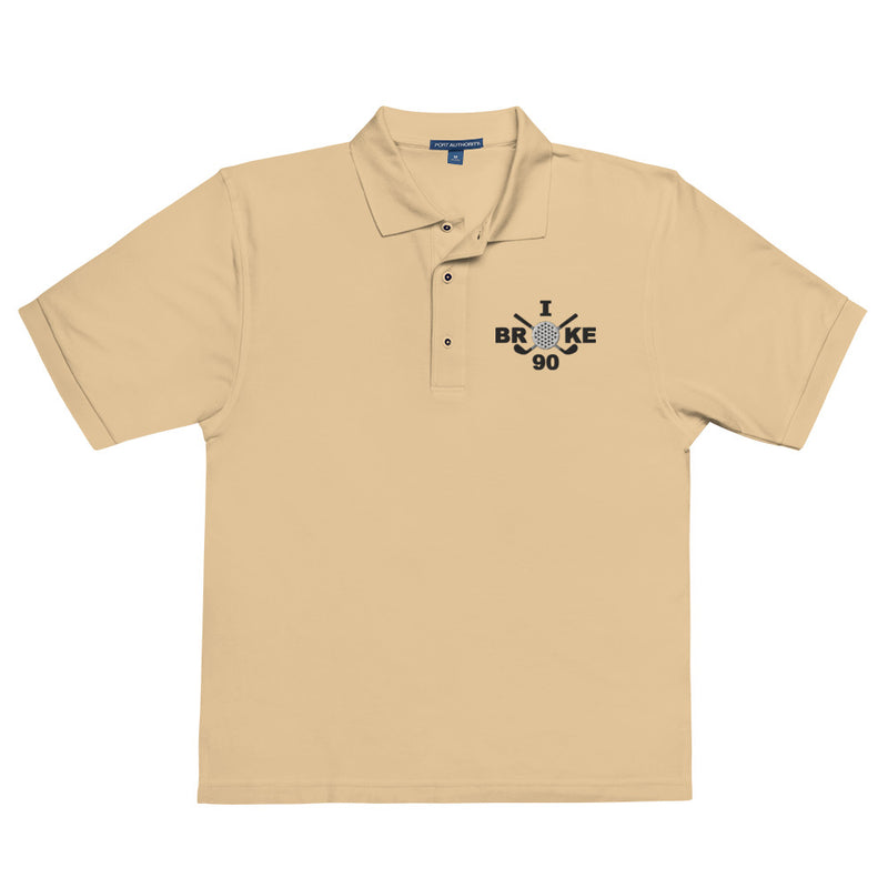 "I Broke 90" - Stone Colored Golf shirt • 65% polyester, 35% cotton pique • Relaxed fit that runs large • Flat knit collar and cuffs